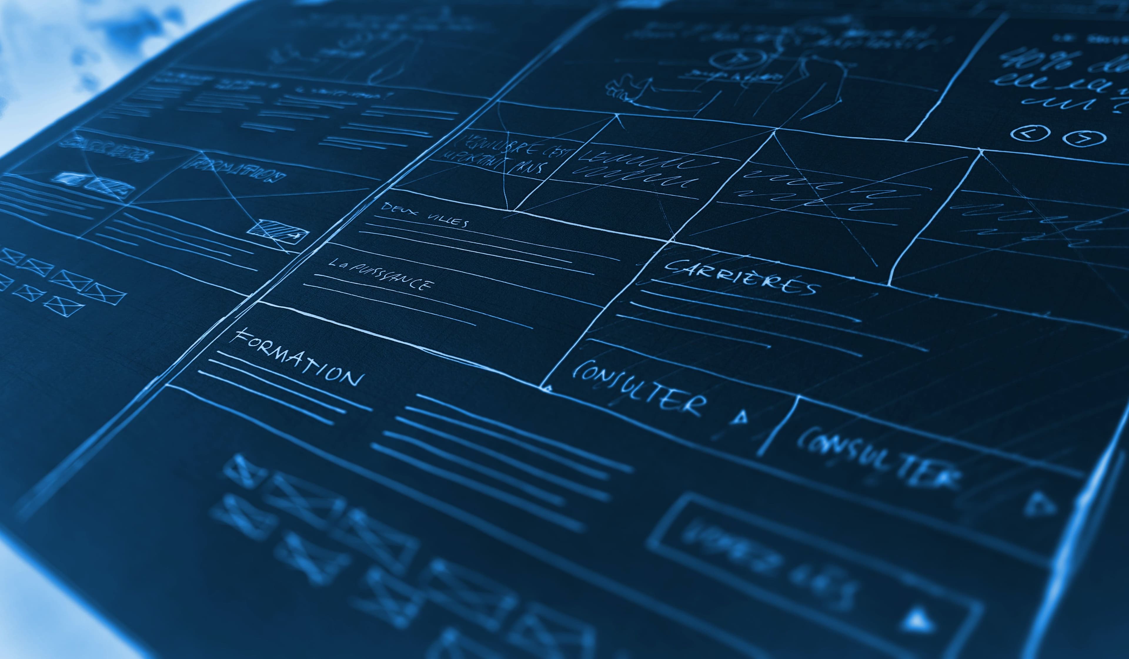 a blueprint style image of white architectural drawings on dark paper